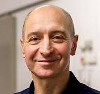 Dr. Dylan Gorvey smiling in a professional indoor setting, wearing a dark collared shirt.