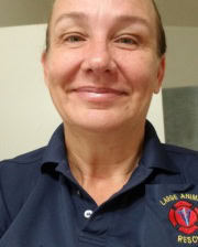 Dr. Rebecca Husted smiling in a navy blue Large Animal Rescue polo shirt.
