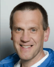 Professional headshot of Dr. Hubert Simhofer wearing a blue jacket and white shirt, smiling against a neutral background.
