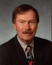 Dr. Jim E. Guenther in professional attire.
