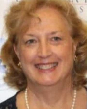 Headshot of Professor Rebecca McConnico smiling and wearing a pearl necklace.